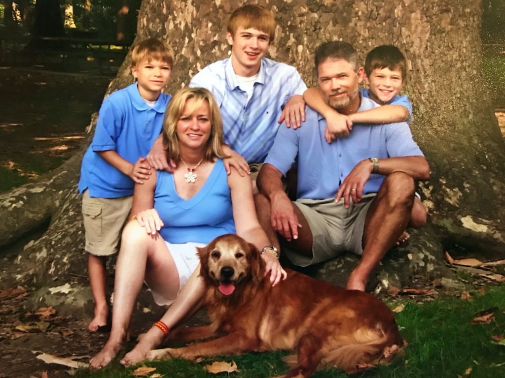 Leslie and her family when their boys were young. Their dog is in the front of the picture. 